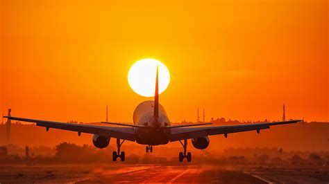 Download Orange (Color) Sun Sunset Passenger Plane Vehicle Aircraft HD Wallpaper