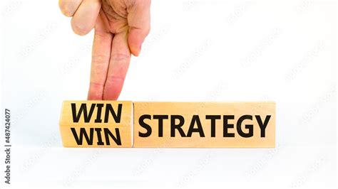 Win-win strategy symbol. Businessman turns wooden cubes with words win ...