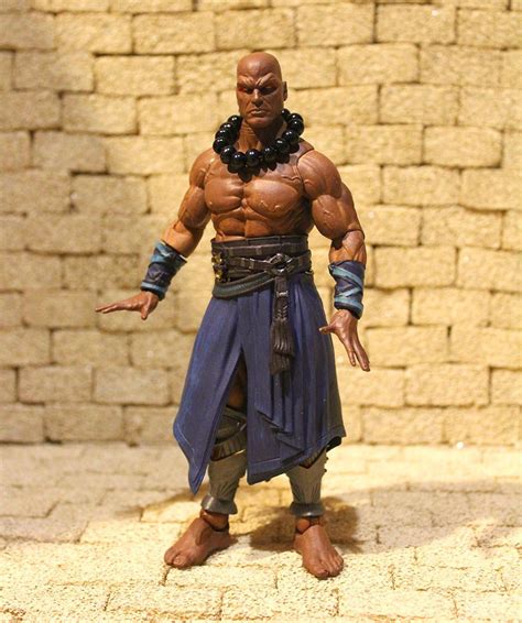 an action figure is posed in front of a brick wall