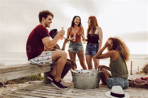 Friends hanging out by the beach stock photo (170624) - YouWorkForThem