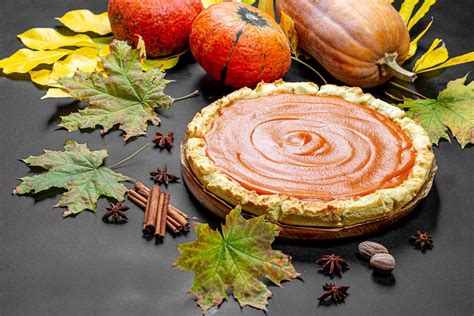 Fresh delicious homemade pumpkin pie with spices, pumpkins and autumn ...