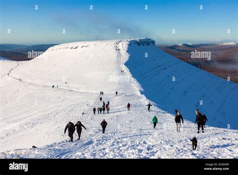 PEN-Y-FAN, WALES, UK - DECEMBER 06 2020: Large numbers of walkers and hikers enjoying fresh snow ...