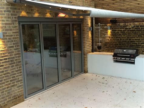 Zenara patio awning with lights by beardsblinds.co.uk | House blinds, Awning design, Patio awning