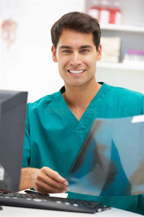 Young Male Hospital Doctor At Desk Stock Photos - Image: 21281193