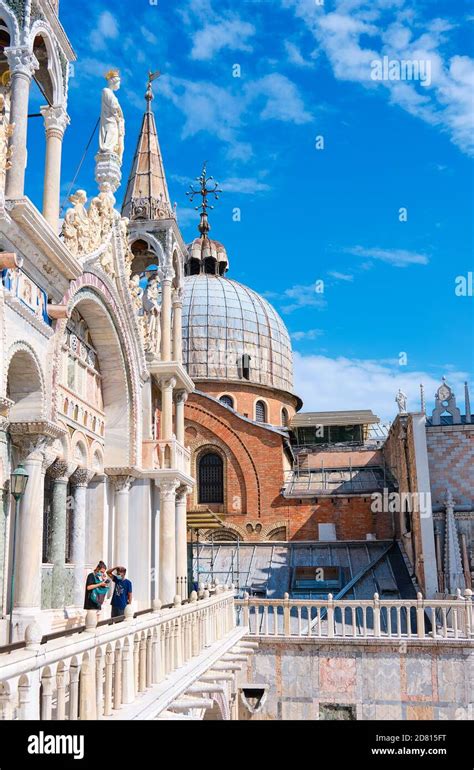 Tourists on the roof of Saint Mark's Basilica, enjoying view of its amazing architecture and ...