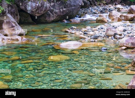 Crystal clear river water flowing over rocks. Nature background Stock ...