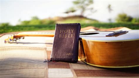 Photo of Holy Bible Near Acoustic Guitar · Free Stock Photo