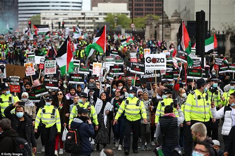 Pro-Palestine protesters in London wave signs saying 'Stop doing what ...