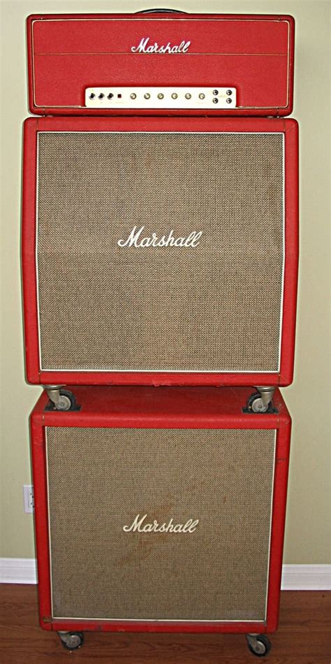 two red marshall amps stacked on top of each other in front of a wall