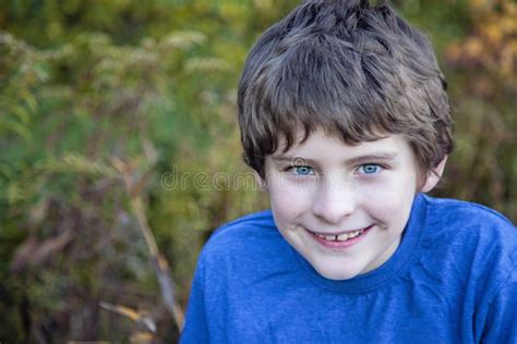 Face of a Smiling Nine Year Old Boy with Blue Eyes Outside Stock Photo - Image of eyes, year ...