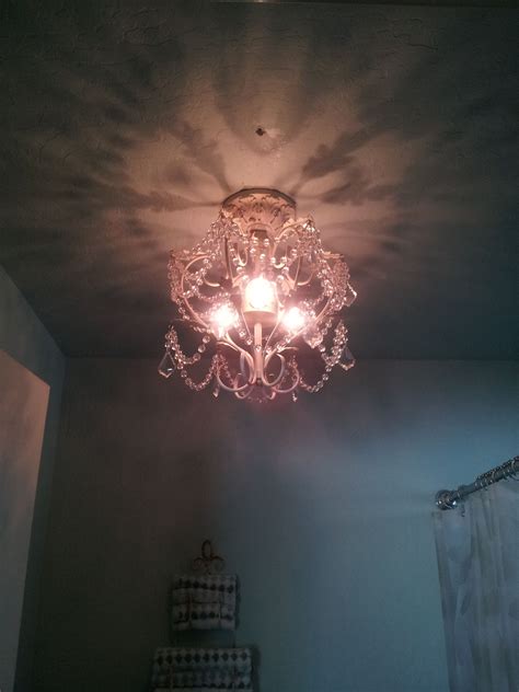 This antique chandelier brings a pop of elegance to an otherwise plain bathroom. Antique ...