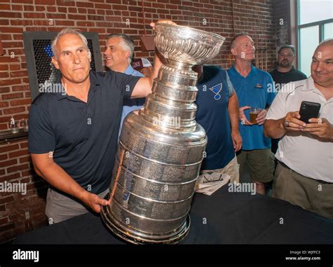 Stanley Cup Champion St. Louis Blues head coach Craig Berube places the cup on a pool table ...