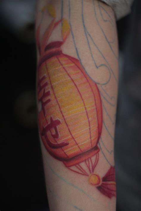 a person with a hot air balloon tattoo on their arm