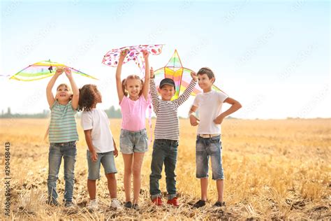 Little children flying kites outdoors Stock Photo | Adobe Stock