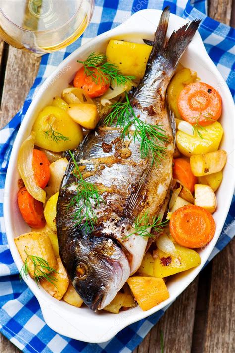 Oven Baked Fish and Vegetables Stock Photo by ©zoryanchik 127302754