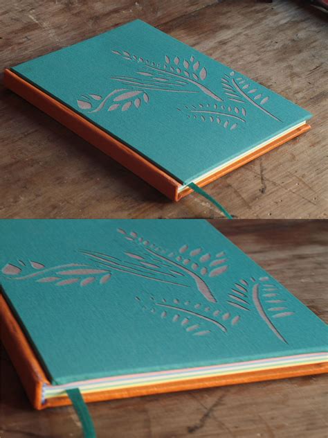 two different views of the inside of a green notebook on a wooden table with scissors