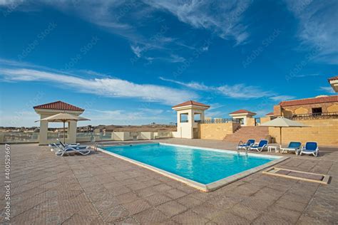 Rooftop swimming pool in a luxury tropical hotel resort Stock Photo ...