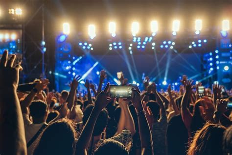 Premium Photo | Concert crowd of Music fanclub hand using cellphone ...