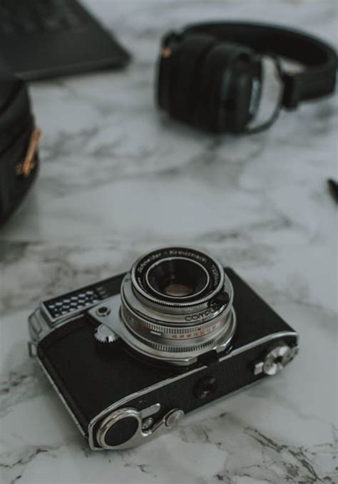 Black and Gray Camera on White Marble Surface · Free Stock Photo