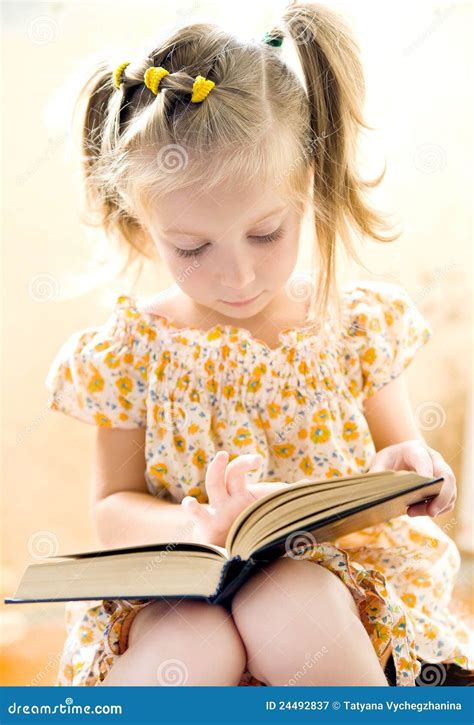 Little girl reading book stock image. Image of people - 24492837