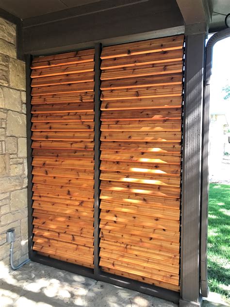 a large wooden sliding door on the side of a building