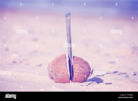 Vintage toned coconut cut in half with knife on a beach Stock Photo - Alamy