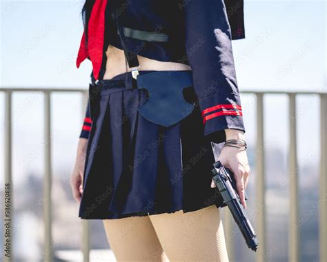 Girl with anime cosplay costume and a gun (similar to a police officer ...