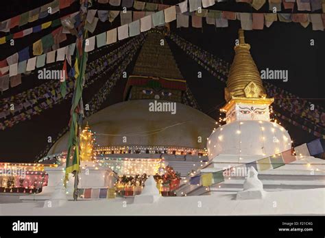 Nepal Kathmandu Night view of the Great Stupa and a mini-stupa in front of it decorated with ...