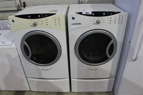 GE FRONT LOAD WASHER AND DRYER SET ON PEDESTALS