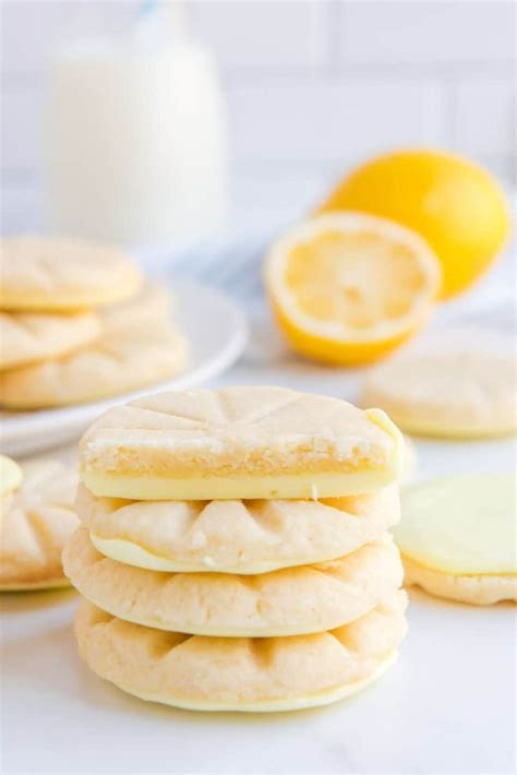 lemon cookies stacked on top of each other next to some sliced lemons ...