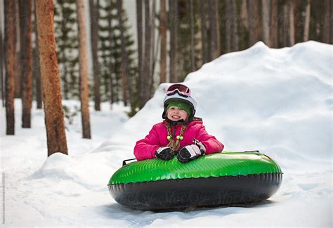 "Girl Smiling After A Fun Toboggan Ride" by Stocksy Contributor "Angela ...