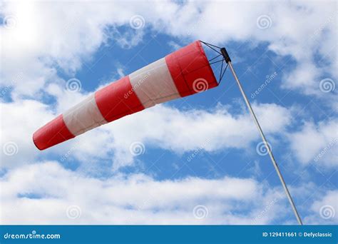 Striped Windsock at Airport on the Background of Beautiful Clouds Stock ...