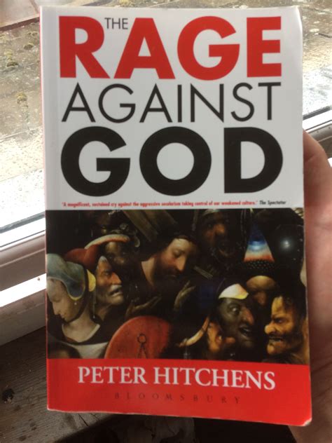 the rage against god by peter hitchens is held up in front of a window