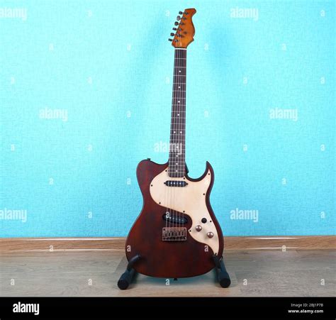 Electric guitar on blue wallpaper background Stock Photo - Alamy