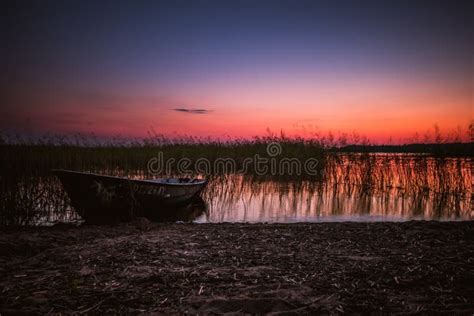 Sunset on the Lake, Fishing Boat on the Shore Editorial Photography - Image of heat, fishing ...