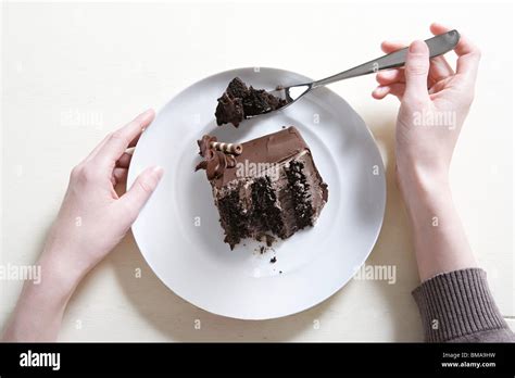 Young woman eating chocolate cake Stock Photo - Alamy