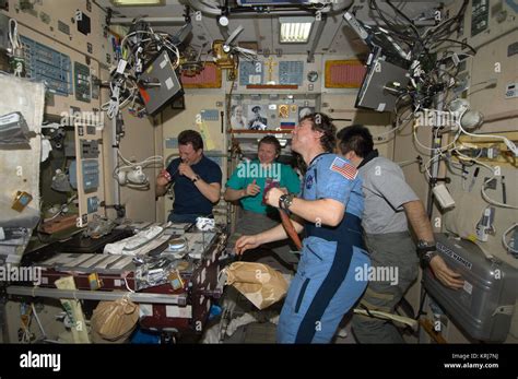 ISS-20 Crew members share a meal at the galley in the Zvezda Service Module Stock Photo - Alamy