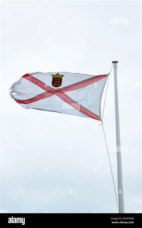 Jersey (Channel Islands) flag straining in the wind of Storm Dennis ...