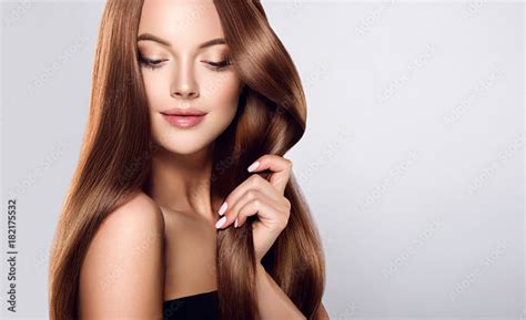 Beautiful brunette girl with long straight smooth hair . A woman with healthy straight hairstyle ...