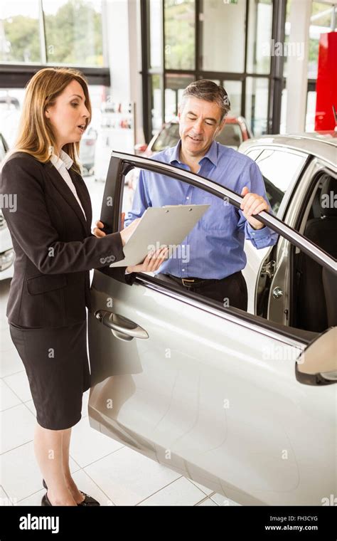 Smiling businessman undersign a car contract Stock Photo - Alamy