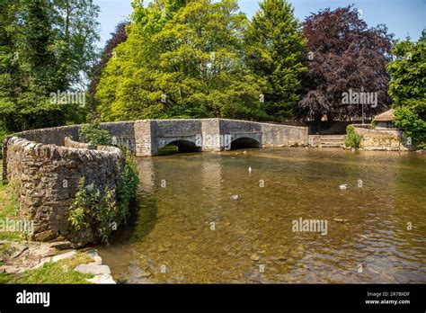 Old packhorse bridge over the river Wye at Ashford-in-the-water in the Derbyshire Dales Peak ...