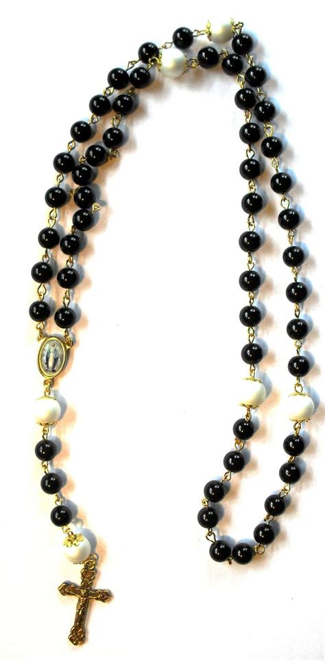 Classic black rosary beads with white feature beads and gold findings ...