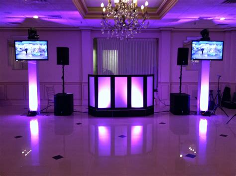 DJ Setup with Purple Lighting and Two Televisions