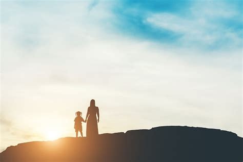 Free Photo | Silhouette of mother with her daughter standing and sunset