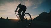 Cyclist Riding Bicycle Uphill On Road In Sunrise Mountains - 4K stock video - Getty Images