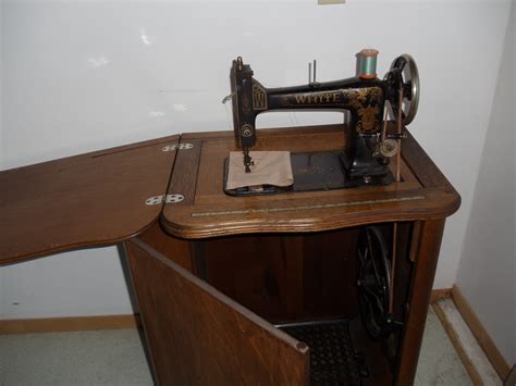 White treadle sewing machine in oak cabinet | Collectors Weekly