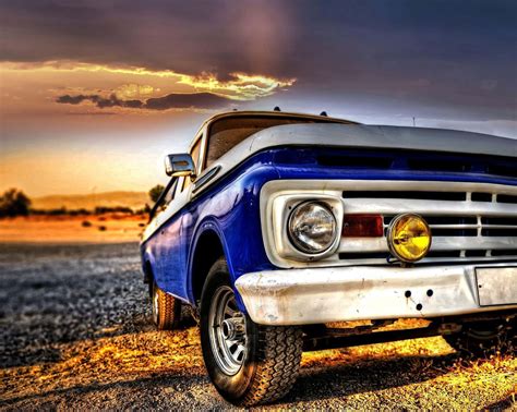 Download A Blue Truck Parked In The Dirt Wallpaper | Wallpapers.com