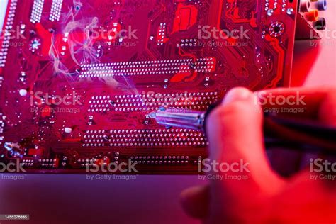 A Man Soldering A Motherboard Repair And Maintenance Of Desktop ...