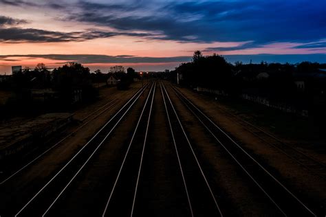 Stainless Steel Train Rails Under Cloudy Sky · Free Stock Photo