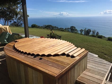 Redwood hot tub, seated in a deck, with a wooden roll-top cover. | Hot tub deck, Hot tub garden ...